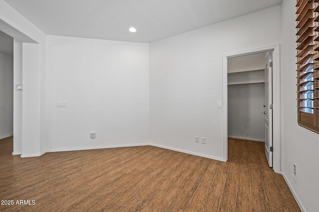 301 S 225th Ave, Buckeye, AZ 85326 - unfurnished bedroom with a closet, baseboards, a walk in closet, and wood finished floors