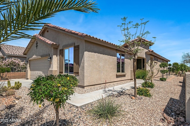 301 S 225th Ave, Buckeye, AZ 85326 - view of home's exterior with a garage, stucco siding, and a tile roof