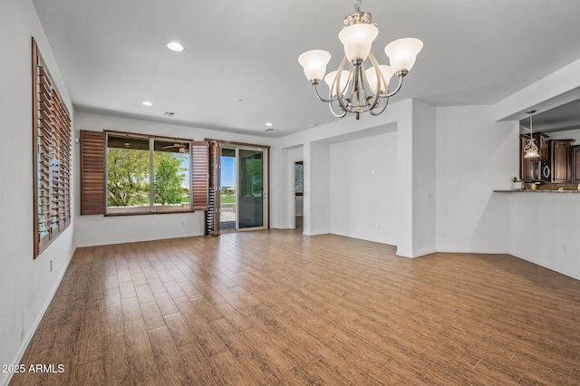301 S 225th Ave, Buckeye, AZ 85326 - interior space with baseboards, recessed lighting, a chandelier, and wood finished floors