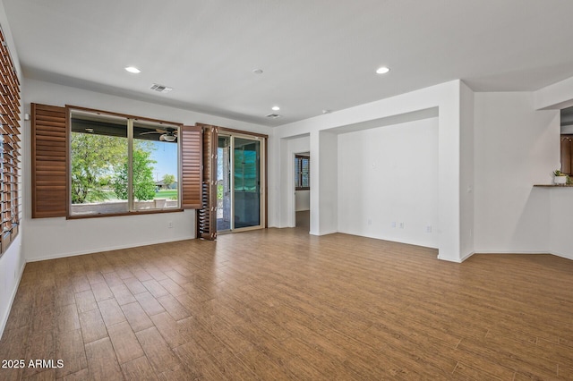 301 S 225th Ave, Buckeye, AZ 85326 - unfurnished living room featuring recessed lighting, visible vents, baseboards, and wood finished floors