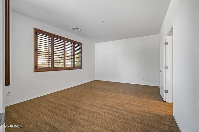 301 S 225th Ave, Buckeye, AZ 85326 - unfurnished room with dark wood-type flooring and visible vents