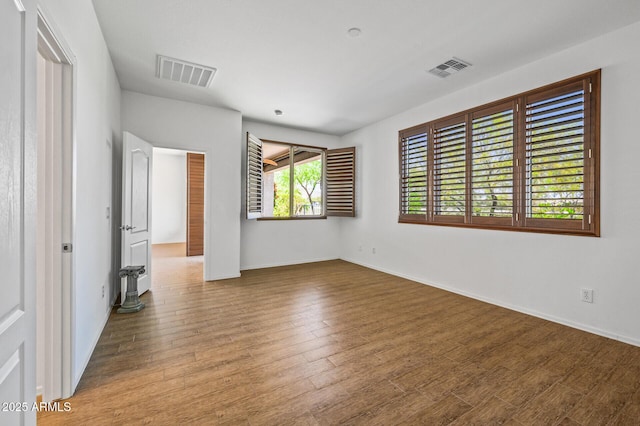 301 S 225th Ave, Buckeye, AZ 85326 - unfurnished bedroom with visible vents, baseboards, and wood finished floors