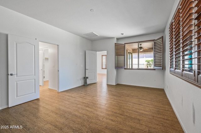 301 S 225th Ave, Buckeye, AZ 85326 - spare room with visible vents, baseboards, a ceiling fan, and wood finished floors