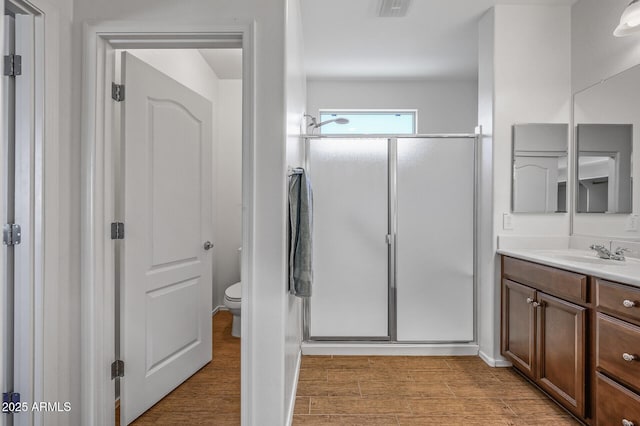301 S 225th Ave, Buckeye, AZ 85326 - full bath with visible vents, toilet, a shower stall, vanity, and wood finished floors