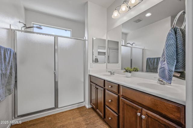 301 S 225th Ave, Buckeye, AZ 85326 - full bath with double vanity, a sink, a stall shower, and wood finished floors