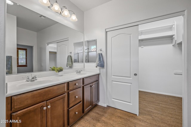 301 S 225th Ave, Buckeye, AZ 85326 - bathroom with a sink, visible vents, double vanity, and wood finished floors