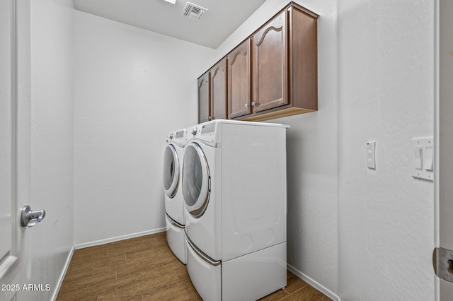 301 S 225th Ave, Buckeye, AZ 85326 - laundry room featuring cabinet space, visible vents, wood finished floors, baseboards, and washing machine and dryer