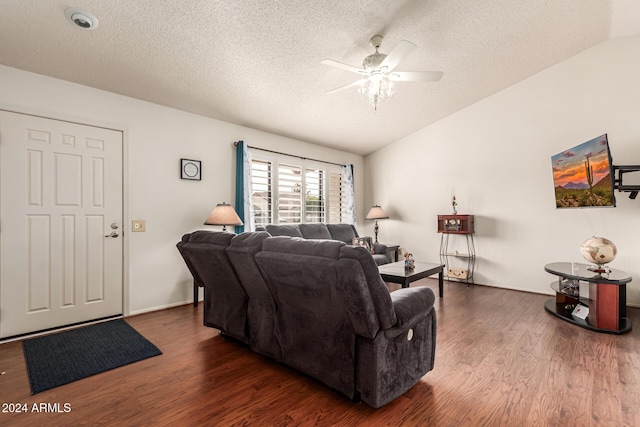 living room featuring a textured ceiling, dark hardwood / wood-style flooring, vaulted ceiling, and ceiling fan