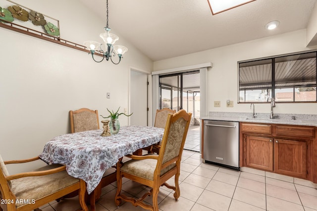 tiled dining area with plenty of natural light, an inviting chandelier, sink, and vaulted ceiling