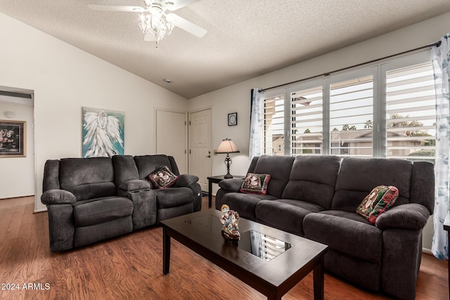 living room featuring a textured ceiling, dark hardwood / wood-style floors, ceiling fan, and lofted ceiling