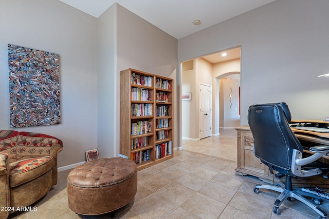 5077 E Lonesome Trl, Cave Creek, AZ 85331 - home office featuring arched walkways, light tile patterned flooring, and baseboards