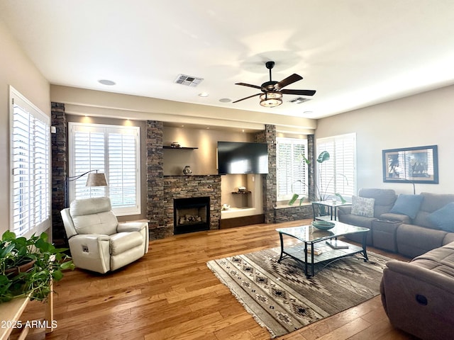 5077 E Lonesome Trl, Cave Creek, AZ 85331 - living room with hardwood / wood-style flooring, ceiling fan, a stone fireplace, and recessed lighting