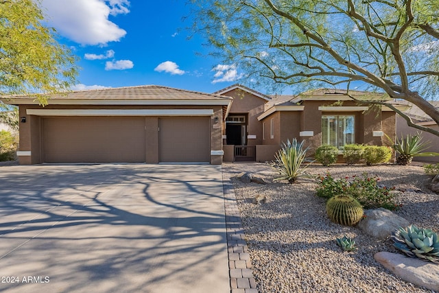 5077 E Lonesome Trl, Cave Creek, AZ 85331 - view of front of property featuring stucco siding, a garage, driveway, and a tile roof