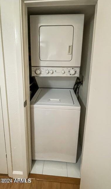 clothes washing area featuring stacked washer / drying machine