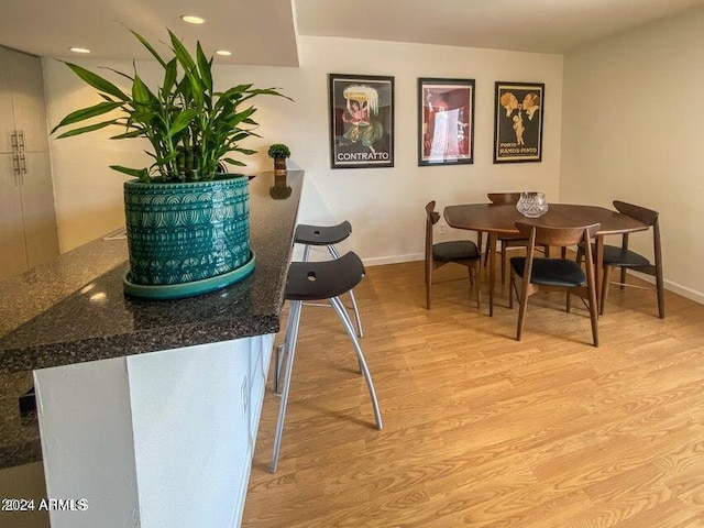 dining space with light hardwood / wood-style floors