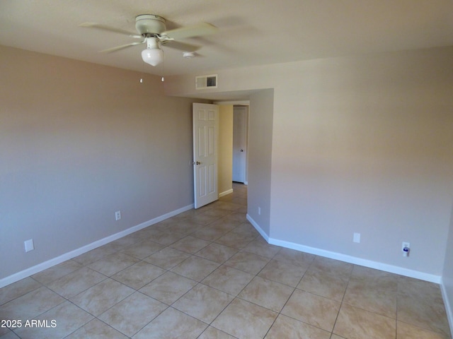 empty room featuring ceiling fan and baseboards