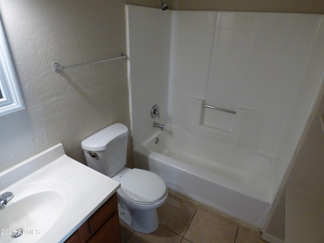 full bathroom with a textured wall, toilet, tile patterned floors, vanity, and washtub / shower combination