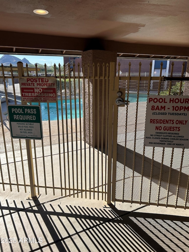 view of pool featuring fence