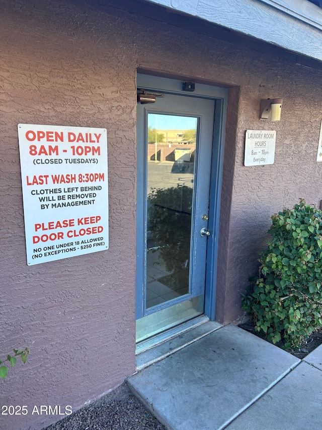 view of exterior entry featuring stucco siding