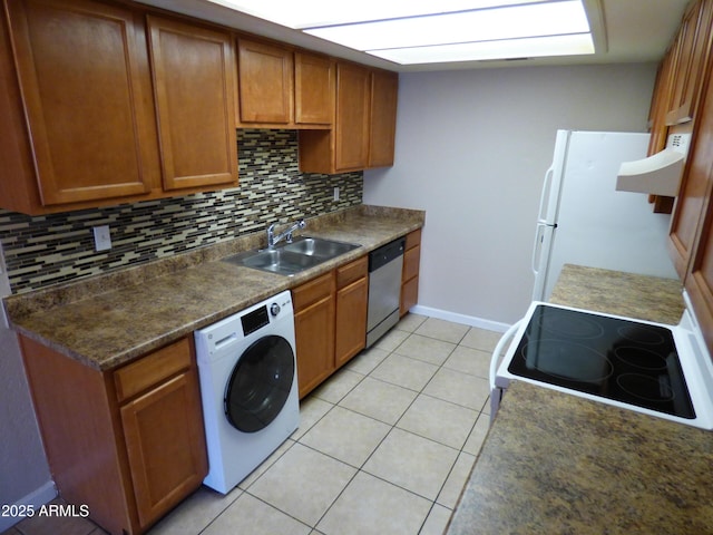 kitchen featuring washer / clothes dryer, a sink, white appliances, and tasteful backsplash