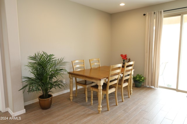 dining space with light hardwood / wood-style flooring