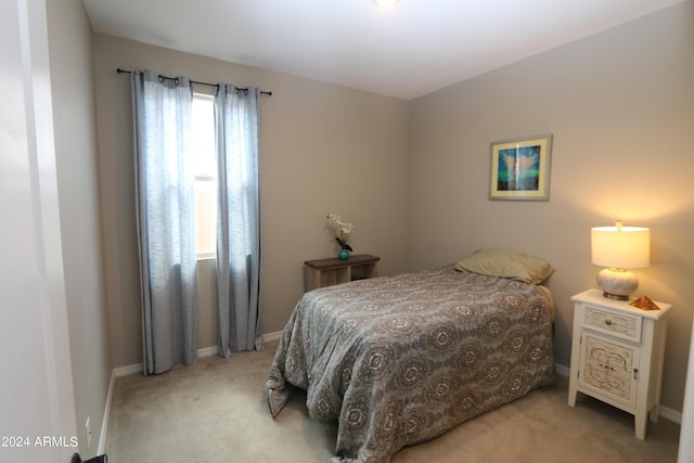 bedroom featuring light carpet