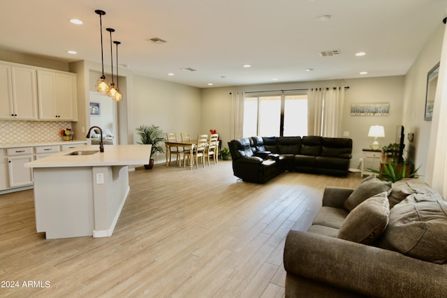 living room featuring light hardwood / wood-style floors and sink