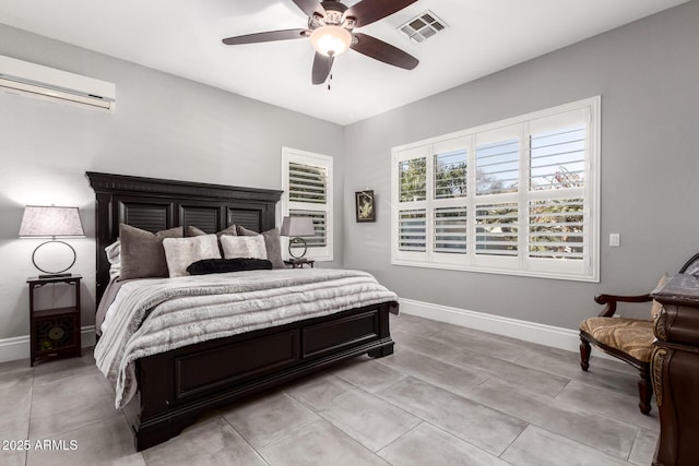 bedroom featuring ceiling fan and a wall unit AC