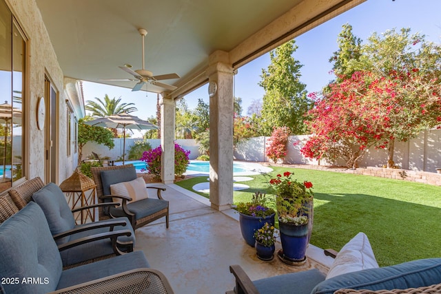 view of patio featuring ceiling fan and a fenced in pool