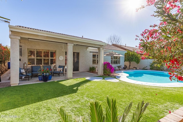 rear view of house with an outdoor hangout area, a yard, a patio, and a fenced in pool