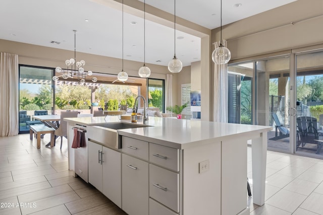 kitchen with dishwasher, sink, decorative light fixtures, a center island with sink, and white cabinets