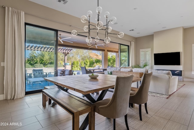 dining room featuring ceiling fan with notable chandelier