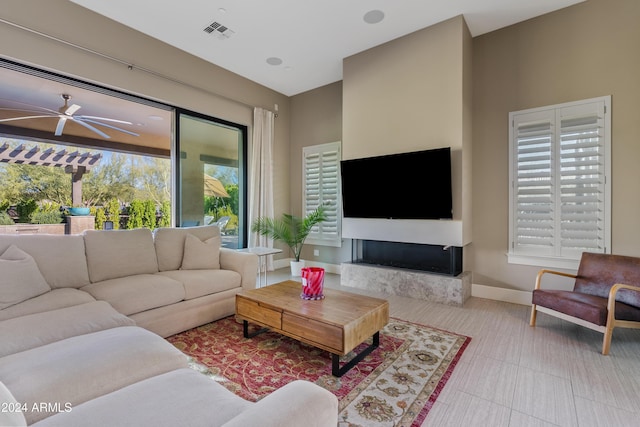 living room with ceiling fan and a wealth of natural light