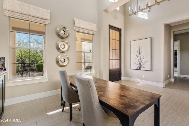 dining room featuring a towering ceiling