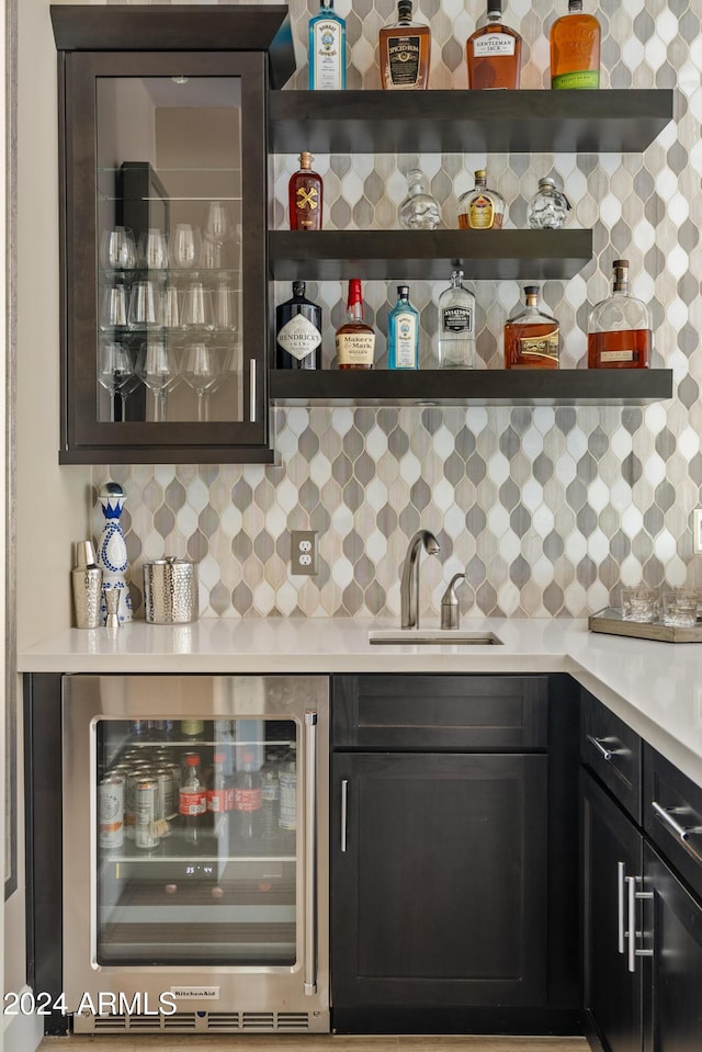 bar with backsplash, wine cooler, and sink