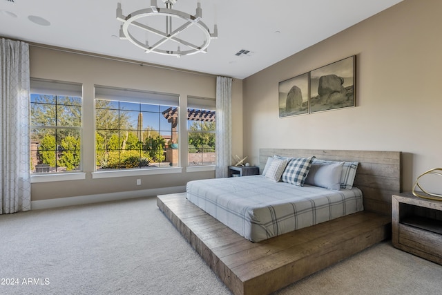 carpeted bedroom with a notable chandelier