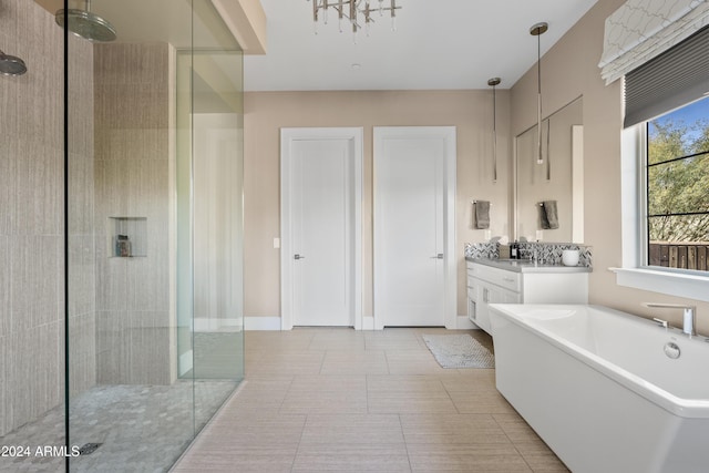 bathroom featuring a chandelier, vanity, tile patterned floors, and independent shower and bath