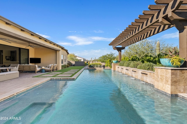 view of pool featuring a pergola, ceiling fan, a patio, and an outdoor hangout area