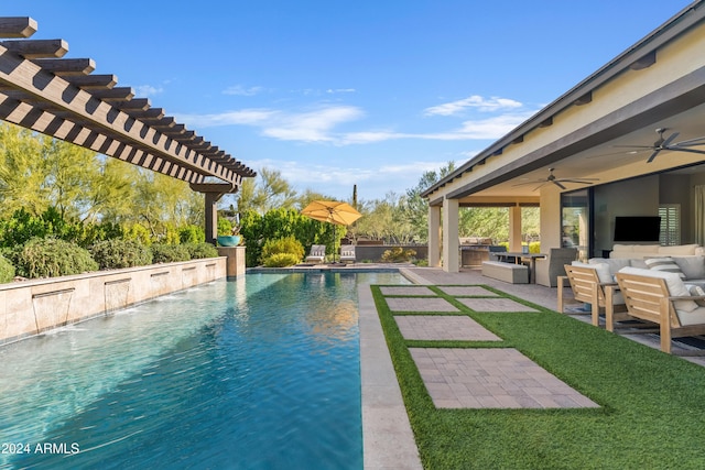 view of swimming pool with an outdoor kitchen, a pergola, pool water feature, ceiling fan, and a patio