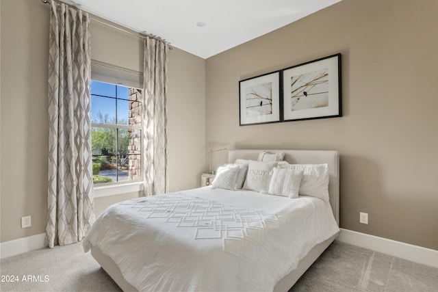 bedroom featuring light colored carpet