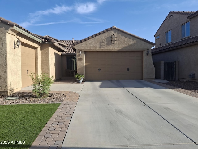 10773 W Prickly Pear Trl, Peoria, AZ 85383 - view of front of property with stucco siding, an attached garage, concrete driveway, and a tiled roof