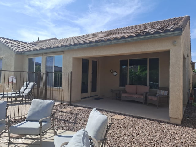 10773 W Prickly Pear Trl, Peoria, AZ 85383 - back of house with an outdoor hangout area, a patio, stucco siding, and a tile roof