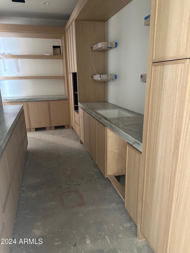 kitchen featuring open shelves, modern cabinets, concrete floors, and light brown cabinetry