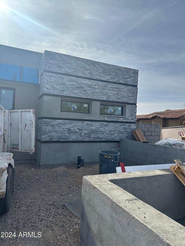 exterior space featuring stone siding