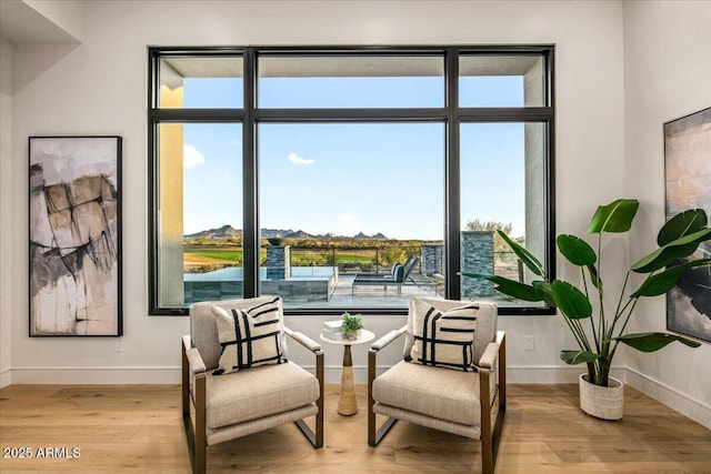 sitting room with light wood-style floors and baseboards