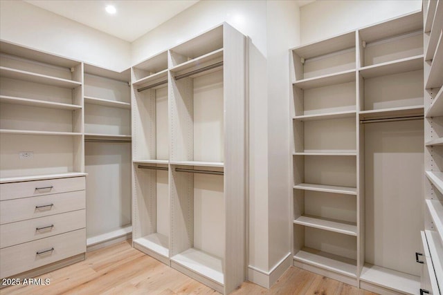 walk in closet featuring light wood-style floors