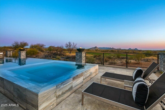 view of pool featuring a patio area, an in ground hot tub, and fence