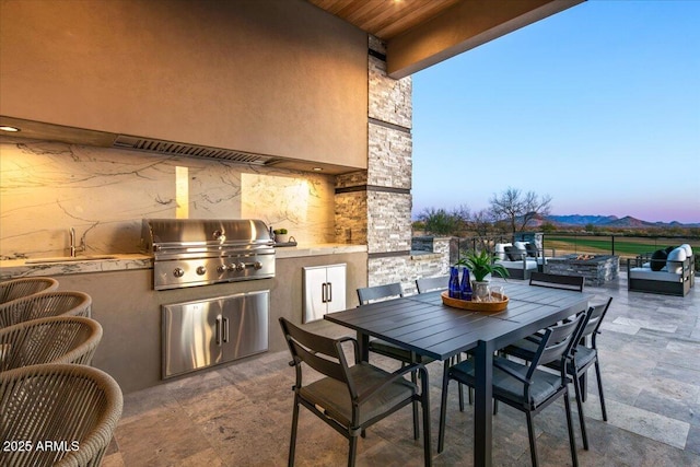 view of patio / terrace featuring area for grilling and outdoor dining area