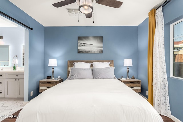 bedroom featuring ensuite bathroom, marble finish floor, visible vents, and a ceiling fan