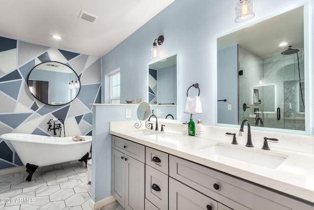 bathroom featuring double vanity, a shower stall, visible vents, and a sink